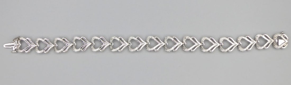 MICRO PAVE CZ HEART MOTIF STERLING LINK BRACELET: MICRO PAVE CZ HEART MOTIF STERLING SILVER LINK BRACELET Height: 3/16 in. by Width: 7 in. by Depth: 7/16 in.
