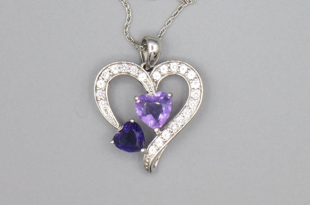 AMETHYST & WHITE TOPAZ HEART STERLING PENDANT: AMETHYST & WHITE TOPAZ HEART STERLING SILVER PENDANT ON 16" CHAIN. Height: 1 in. by Width: 13/16 in. by Depth: 1/4 in.