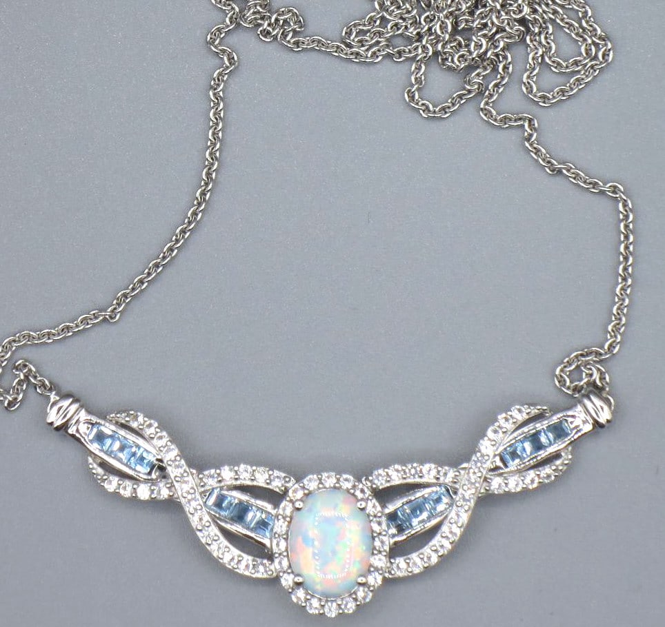 OPAL, BLUE SAPPHIRE, WH TOPAZ STERLING PENDANT: OPAL, BLUE SAPPHIRE, WH TOPAZ STERLING SILVER PENDANT ON 16" NECKLACE. Height: .5 in. by Width: 2 in. by Depth: 1/4 in.