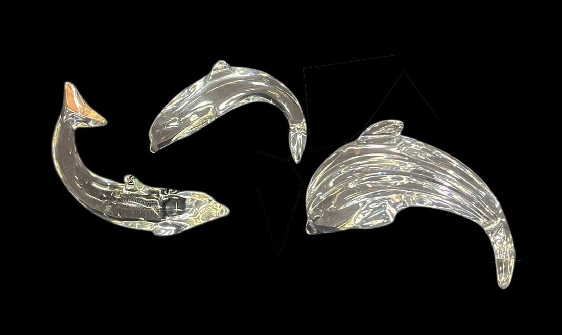 THREE BACCARAT CRYSTAL DOLPHINS: THREE BACCARAT CRYSTAL DOLPHINS. Height: 3 in. by Width: 5 in. by Depth: 2 in.