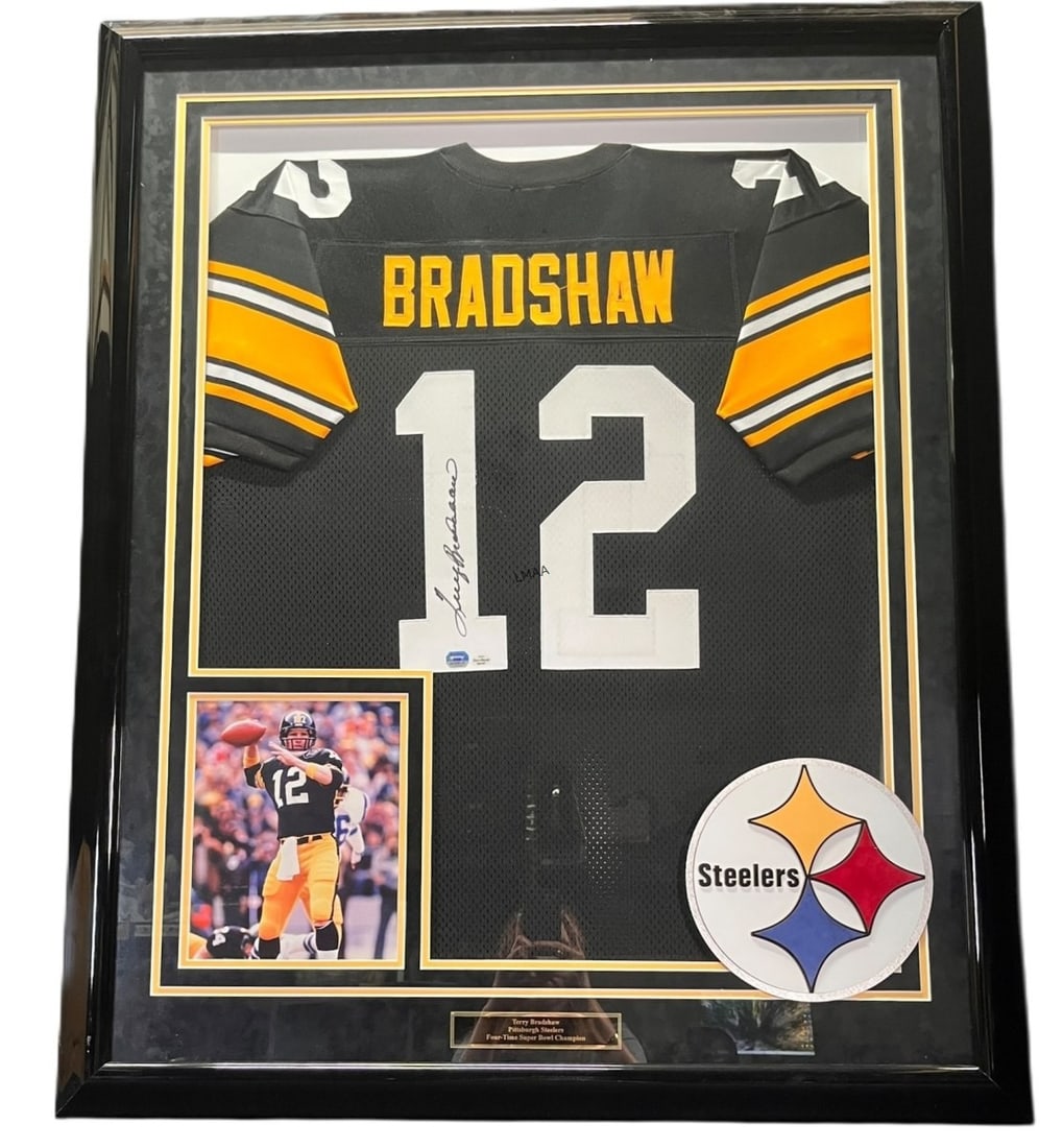 TERRY BRADSHAW AUTOGRAPHED JERSEY FRAMED: TERRY BRADSHAW AUTOGRAPHED JERSEY FRAMED. Height: 43.5 in. by Width: 35.5 in. by Depth: 2 in.