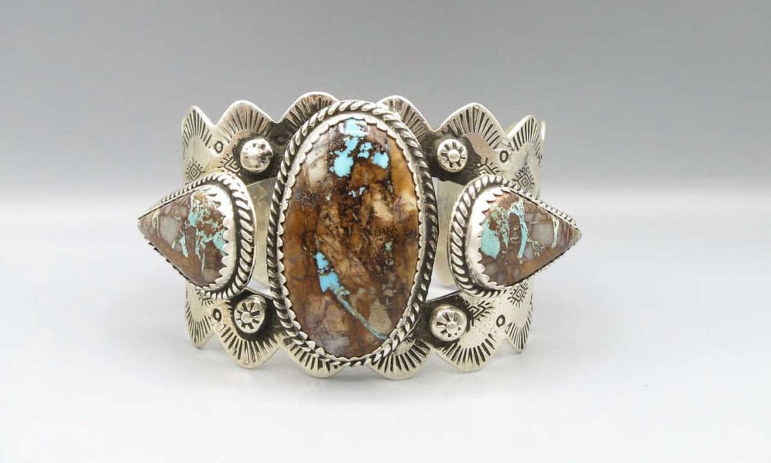 STERING SILVER THREE-STONE TURQUOISE CUFF BRACELET: STERING SILVER THREE-STONE TURQUOISE CUFF BRACELET. Height: 2 in. by Width: 3 & 2.5 in. by Depth: 2 1/4 & 1 3/4 in.
