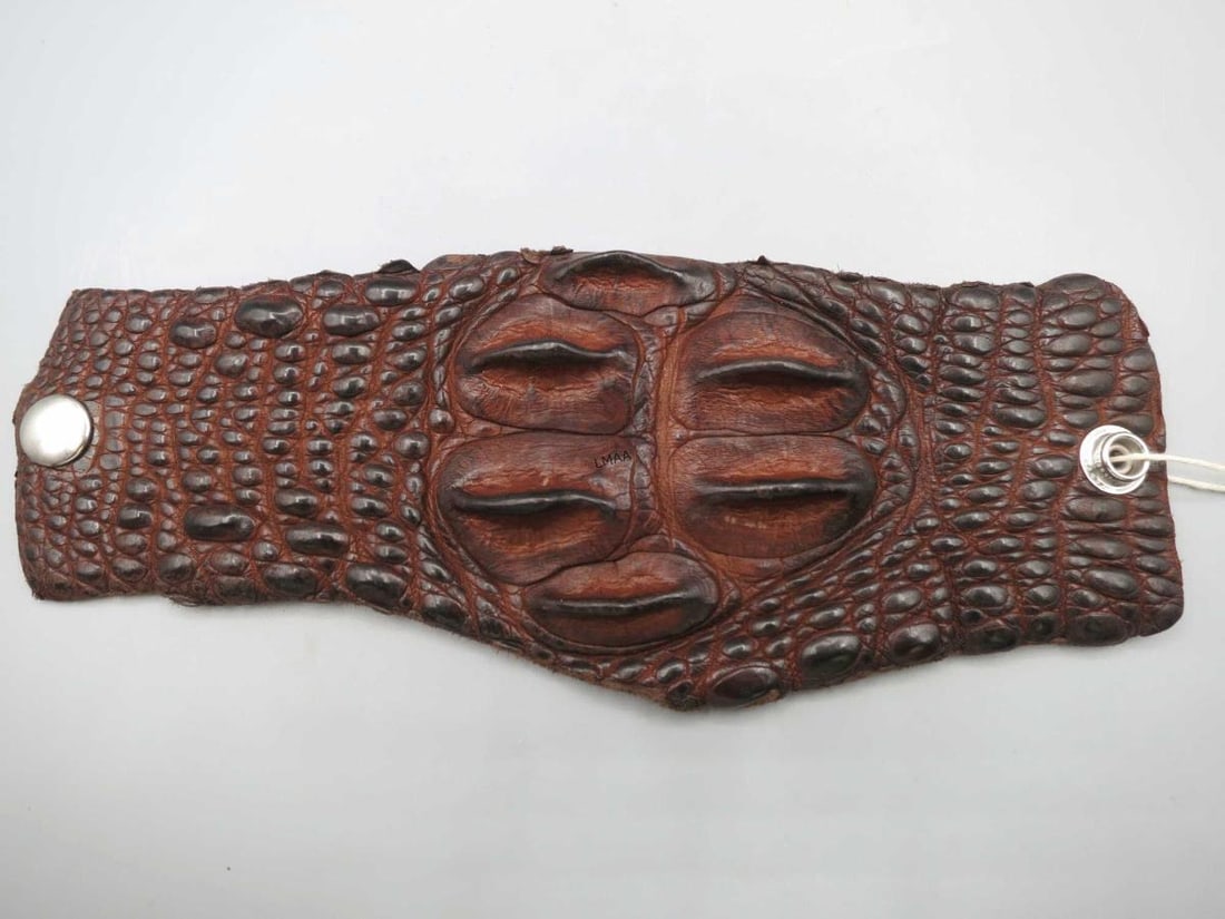 MEN'S AUSTRALIAN CROCODILE CUFF BRACELET: MEN'S DARK BROWN CUFF BRACELET MADE WITH GENUINE AUSTRAILIAN CROCODILE WITH SNAP CLOSURES AT BOTH ENDS TO WRAP AROUND WRIST SIZE 8 3/4 Height: 9 in. by Width: .3.5 in. by Depth: .5 in.
