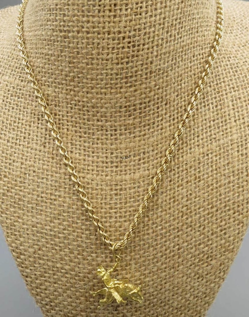 GOLD BULL RIDER ON HORSEBACK PENDANT ON CHAIN: GOLD BULL RIDER ON HORSEBACK PENDANT ON 16" CHAIN. Height: 1 in. by Width: 1 in. by Depth: 5/8 in.