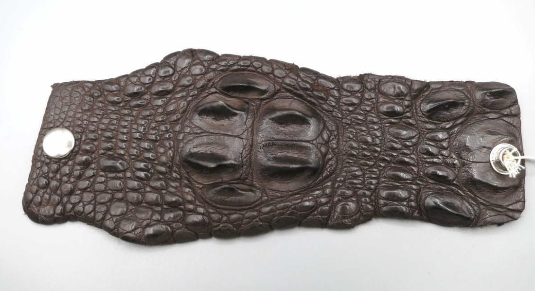 MEN'S CUFF BRACELET W GENUINE AUSTRALIAN CROCODILE: MEN'S DARK BROWN CUFF BRACELET MADE WITH GENUINE AUSTRAILIAN CROCODILE WITH SNAP CLOSURES AT BOTH ENDS TO WRAP AROUND WRIST SIZE 8" Height: 3.25 in. by Width: 8.5 in. by Depth: .5 in.