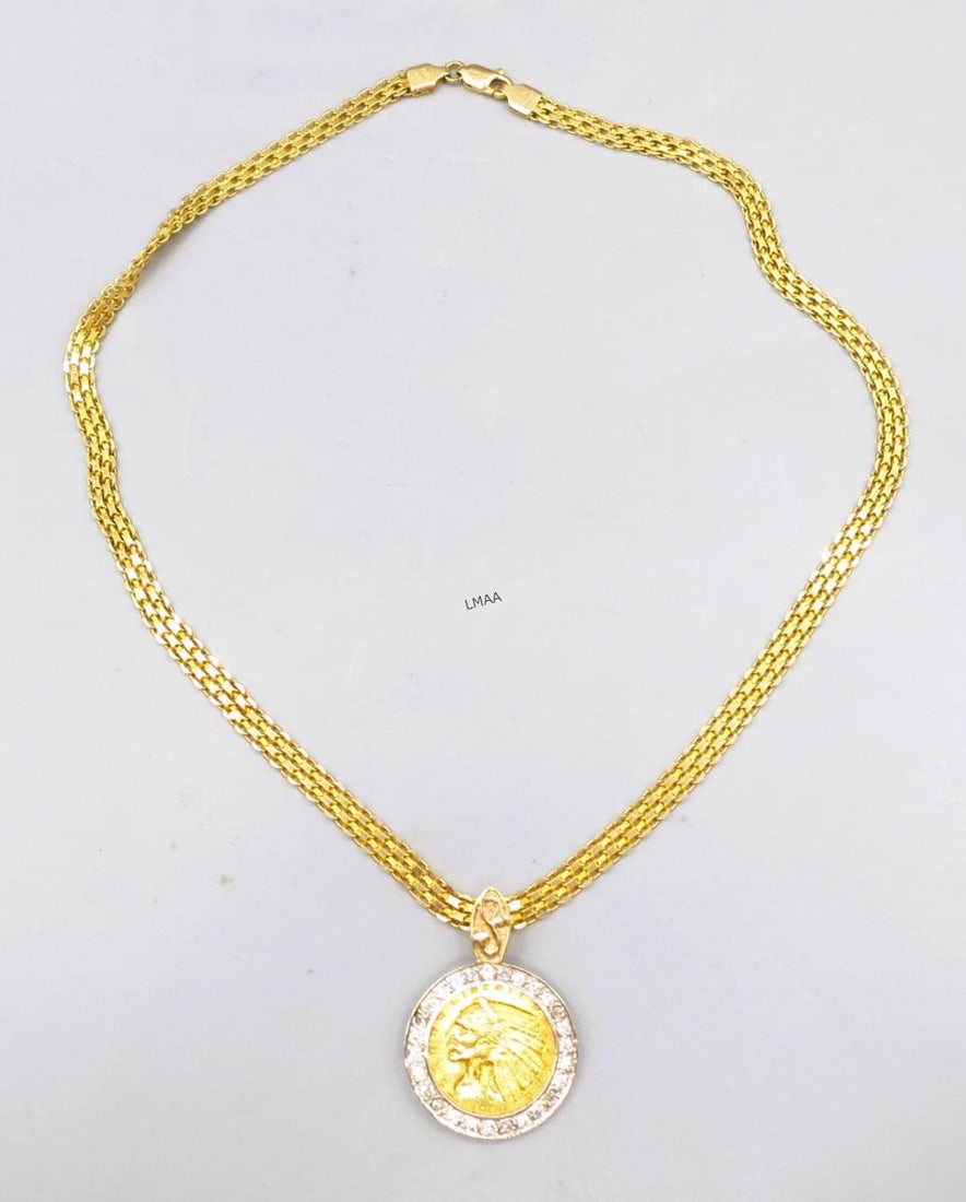 1908 INDIAN GOLD COIN PENDANT IN DIAMOND BEZEL: 1908 INDIAN HEAD GOLD COIN PENDANT SET IN A DIAMOND ACCENTED TWO-TONE GOLD BEZEL ON A ITALIAN MILER 15.5 INCH 14KT YELLOW GOLD CHAIN. 17 GRAMS T.W. Height: 1.25 in. by Width: 7/8 in. by Depth: 1/8 in.