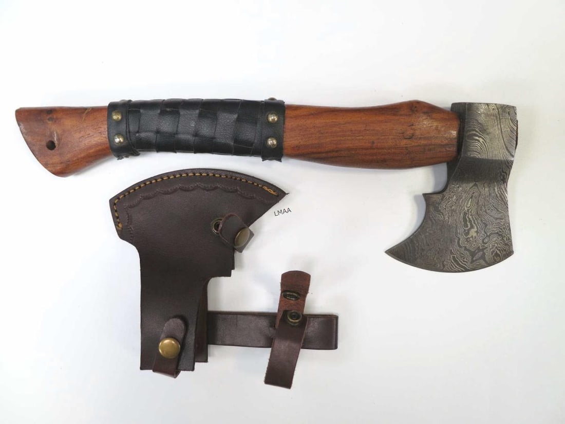 HAND MADE DAMASCUS STEEL BEARDED AXE: HAND MADE DAMASCUS STEEL BEARDED AXE WITH A WAVY PATTERN ON THE BLADE. WOODEN HANDLE PARTIALLY WRAPPED IN BLACK LEATHER FOR IMPROVED GRIP. COMES WITH A LEATHER SHEATH DESIGNED FOR BELT CARRY. Height: