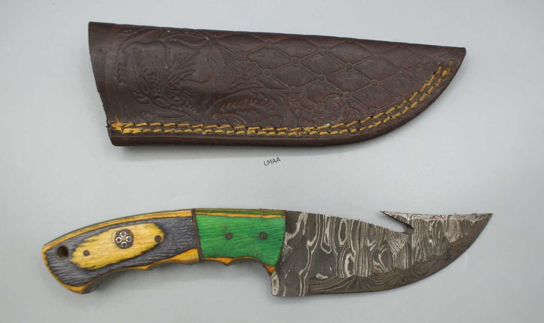 HANDMADE DAMASCUS STEEL FIXED-BLADE KNIFE: HANDMADE DAMASCUS STEEL FIXED-BLADE KNIFE FEATURING A GUT HOOK FOR SKINNING GAME AND A DISTINCTIVE WOODEN HANDLE. Height: 1.5 in. by Width: 8 in. by Depth: 5/8 in.