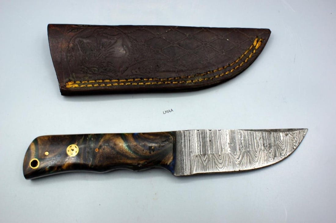 HANDMADE DAMASCUS STEEL FIXED-BLADE HUNTING KNIFE: HANDMADE DAMASCUS STEEL FIXED-BLADE HUNTING KNIFE FEATURING A DISTINCTIVE RESIN & WOOD HANDLE AND EMBOSSED AND STITCHED LEATHER SHEATH. Height: 1.25 in. by Width: 8 in. by Depth: 5/8 in.