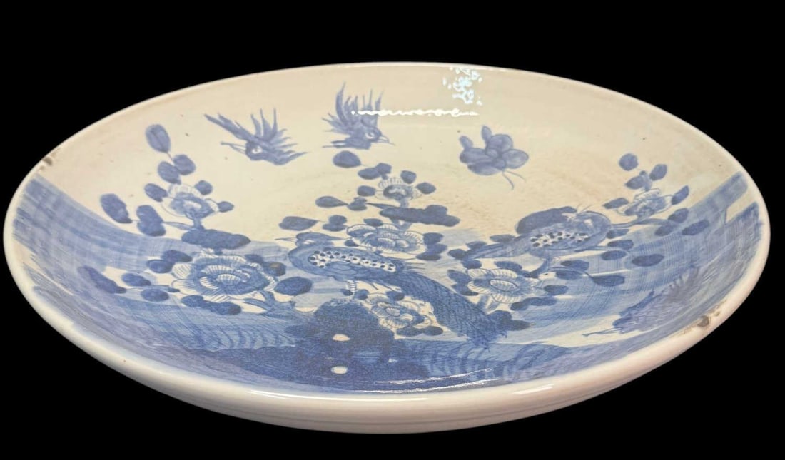 CHINESE BLUE-AND-WHITE PORCELAIN CHARGER: CHINESE BLUE-AND-WHITE PORCELAIN CHARGER. LARGE PORCELAIN BOWL PAINTED IN UNDERGLAZE BLUE WITH FLOWERING BRANCHES, BIRDS, AND LANDSCAPE ELEMENTS. Height: 3 in. by Width: 16.5 in. by Depth: 16.5