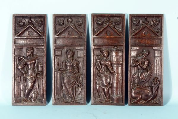 FOUR 16th CENTURY OAK CARVED PANELS: FOUR 16th CENTURY OAK CARVED PANELS DEPICTING THE FOLLOWING ROMAN CATHOLIC SAINTS, IDENTIFIED BY THEIR ATTRIBUTES, FROM LEFT TO RIGHT: MARY MAGDALENE WITH JUG OF OINTMENT; CATHERINE OF ALEXANDRIA, WIT