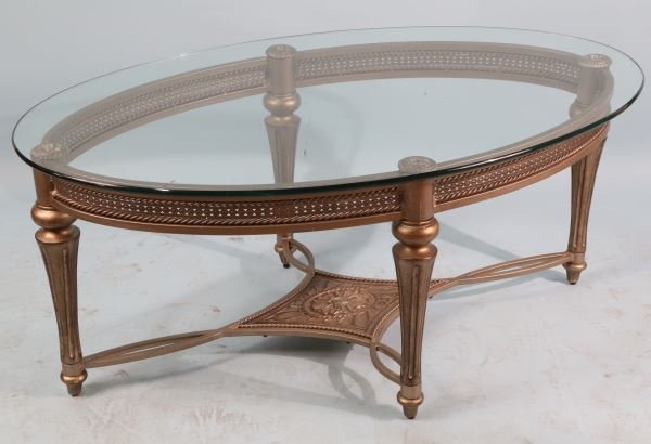 OVAL SHAPED GLASS TOP COFFEE TABLE: OVAL SHAPED GLASS TOP COFFEE TABLE Height: 19 in. by Width: 46 in. by Depth: 28 in.