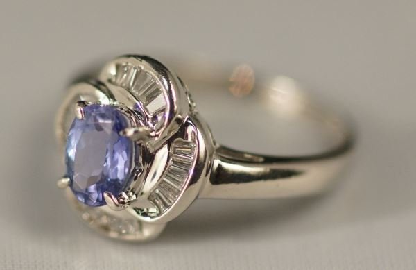 STAMPED "PT900" PLATINUM DIAMOND & TANZANITE RING: A STAMPED "PT900" PLATINUM DIAMOND AND TANZANITE RING. THE 7 MM X 5 MM OVAL NATURAL TANZANITE IS A DEEP, VIVID BLUE WITH PURPLISH TINGE. THIS AAA QUALITY TANZINITE WEIGHS APPROX. 0.80 CTS. THERE ARE N