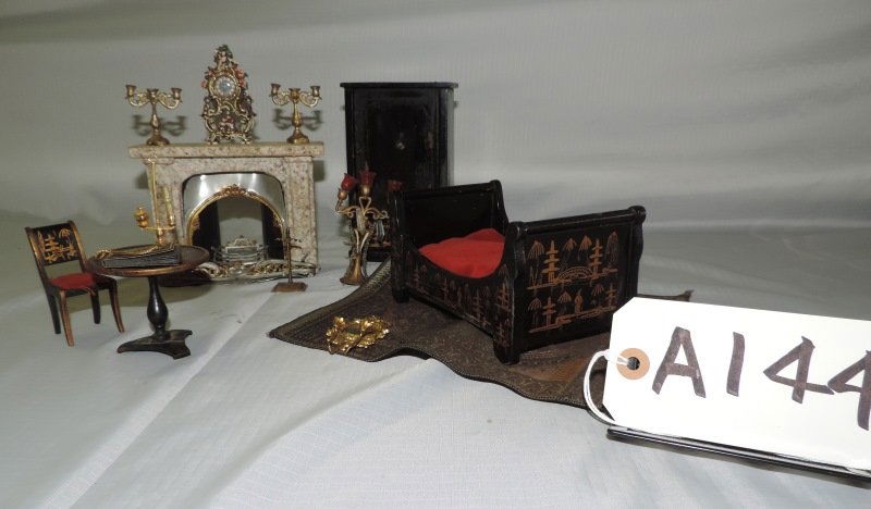 Misc. doll furniture: Misc. doll furniture: Oriental style black lacquer bed, chest, table, chair, marble fireplace, with brass candelabras, hanging brass clock, and rug.