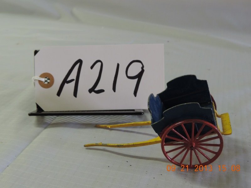 Cast iron yellow, red wheeled and black cart: Cast iron yellow, red wheeled and black cart, made in England. a219