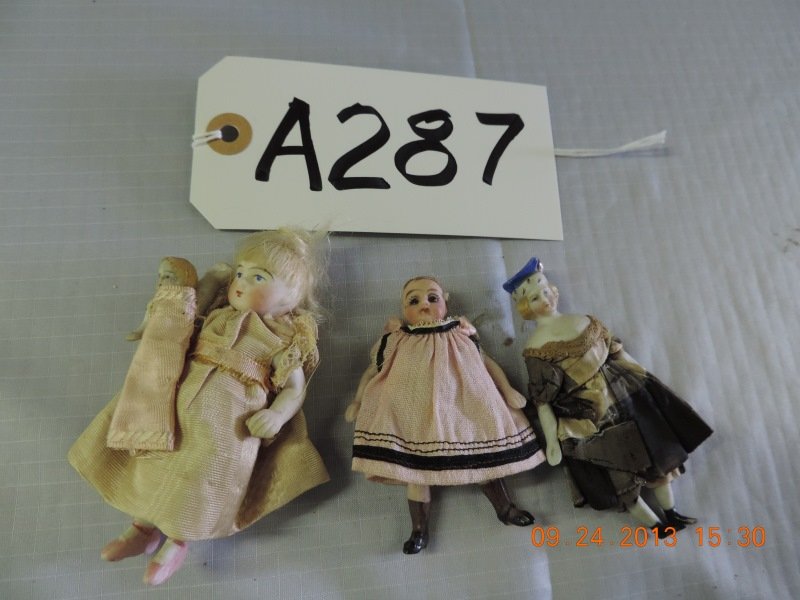 Lot of 3 Dolls: Lot of 3 Dolls Toddler with glass eyes, needs wig. 3”.Bisque doll with blonde hair and blue hat 3 1/2”. Child with doll 3 1/2”. a287