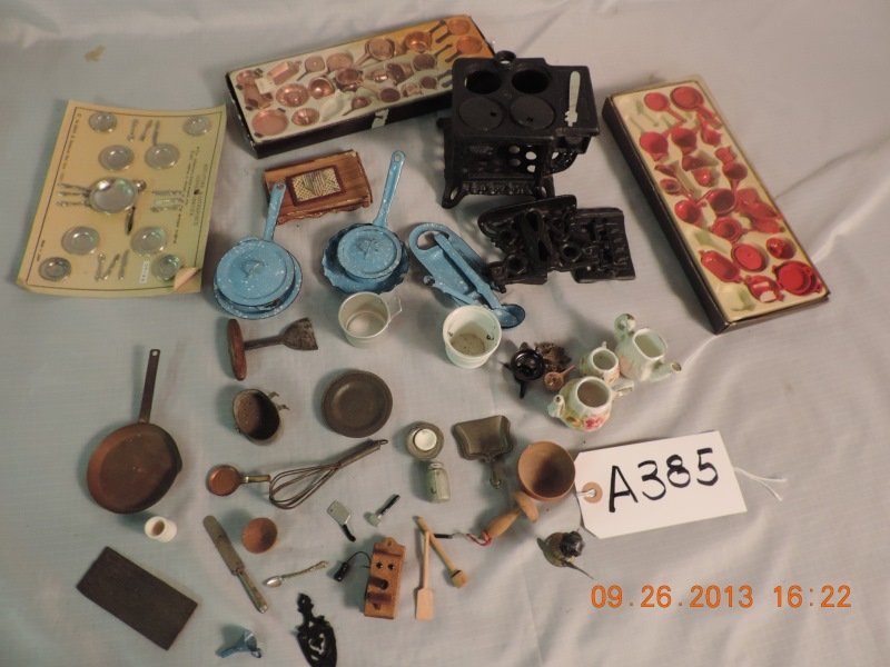 Kitchen: Cast iron, needs repair, blue set of cooe: Kitchen: Cast iron, needs repair, blue set of cookware, some small utensils, new red cookware, new copper colored set, plates, knives, forks, dinner service. A385