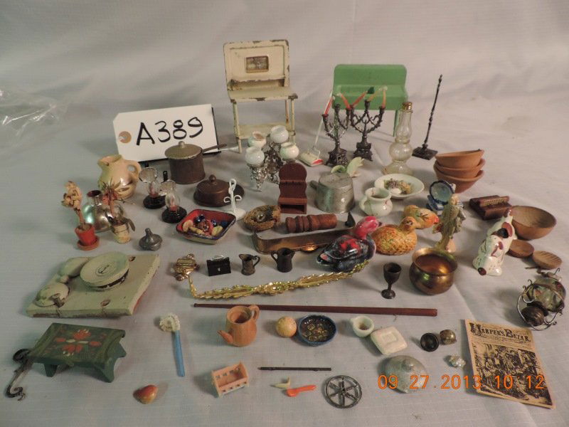 Misc. small items: brass fireplace surround, silvl: Misc. small items: brass fireplace surround, silver metal chandelier, 3 1/2” ceramic spotted dog, 1 orange hen, 1 glass bottle that held candy with lid, pair metal candelabras - 3 branch,wooden blue