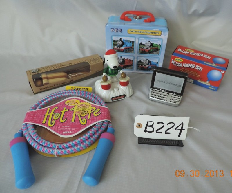 Bamboo cup and ball game, balloon powered boat, Sn: Bamboo cup and ball game, balloon powered boat, Snoopy drummer, ceramic computer ornament, 7’ jump rope, Pez “Thomas the Train” collectible dispensers. B224