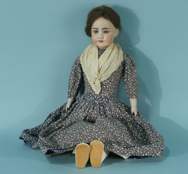 ANTIQUE DOLL: ANTIQUE DOLL. 100 YEAR OLD PORCELAIN HEAD WITH GLASS EYES, HUMAN HAIR WIG, KID GLOVE BODY STUFFED WITH SAWDUST, BISQUE FEET AND HANDS. SLIGHT SAWDUST LEAK, SOLD AS IS. Height: 22 in. by Width: 8 in. b