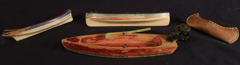 LOT OF FOUR VINTAGE TOY BOATS: LOT OF FOUR VINTAGE TOY BOATS. BIRCH BARK WIND UP BOAT (WORKS, ONE OAR MISSING), FOUR SEATER BOAT, THREE SEATER "ROUSES POINT, NY" BOAT (ONLY ONE OAR), LEATHER INDIAN CANOE. Height: 2 and 1 1/2 and 1