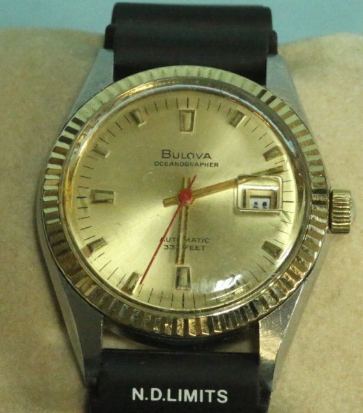 10 KT S. S. MEN'S BULOVA AUTOMATIC WATCH: A STAMPED 10 KT STAINLESS STEEL MEN'S BULOVA AUTOMATIC OCEANOGRAPHIC WRIST WATCH. THIS CIRCA 1960's WATCH IS LISTED WATERPROOF TO 330 FT. AND HAS DATE FEATURE. 17-JEWEL, SWISS BULOVA, ILLUMINANCE WITH