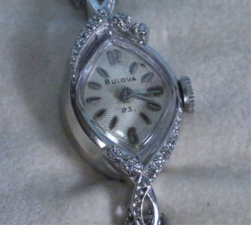 14KT WHITE GOLD & DIAMOND LADIES BULOVA WATCH: A STAMPED 14KT WHITE GOLD & DIAMOND LADIES BULOVA WATCH. THIS U.S. MADE 23-JEWEL MANUAL WATCH KEEPS GOOD TIME. THE CIRCA 1960's WATCH HAS 14 DIAMONDS, APPROX. 0.15 CTS. APPROX. WATCH WEIGHT: 7.1 GRAMS