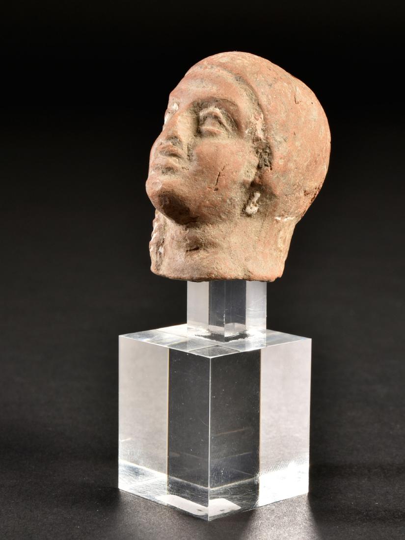 An Egyptian Head of Harpokrates (Ancient Egyptian Art): KÖPFCHEN DES HAPOKRATES Alexandrinisch, Ägypten, 3. - 2. Jh. v. Chr. Mit Sockel / with base Keramik. H 4,5 cm. Provenienz: Sammlung Hofmann, Berlin (vor 1939). CHF 75 / 150 EUR 64 / 129