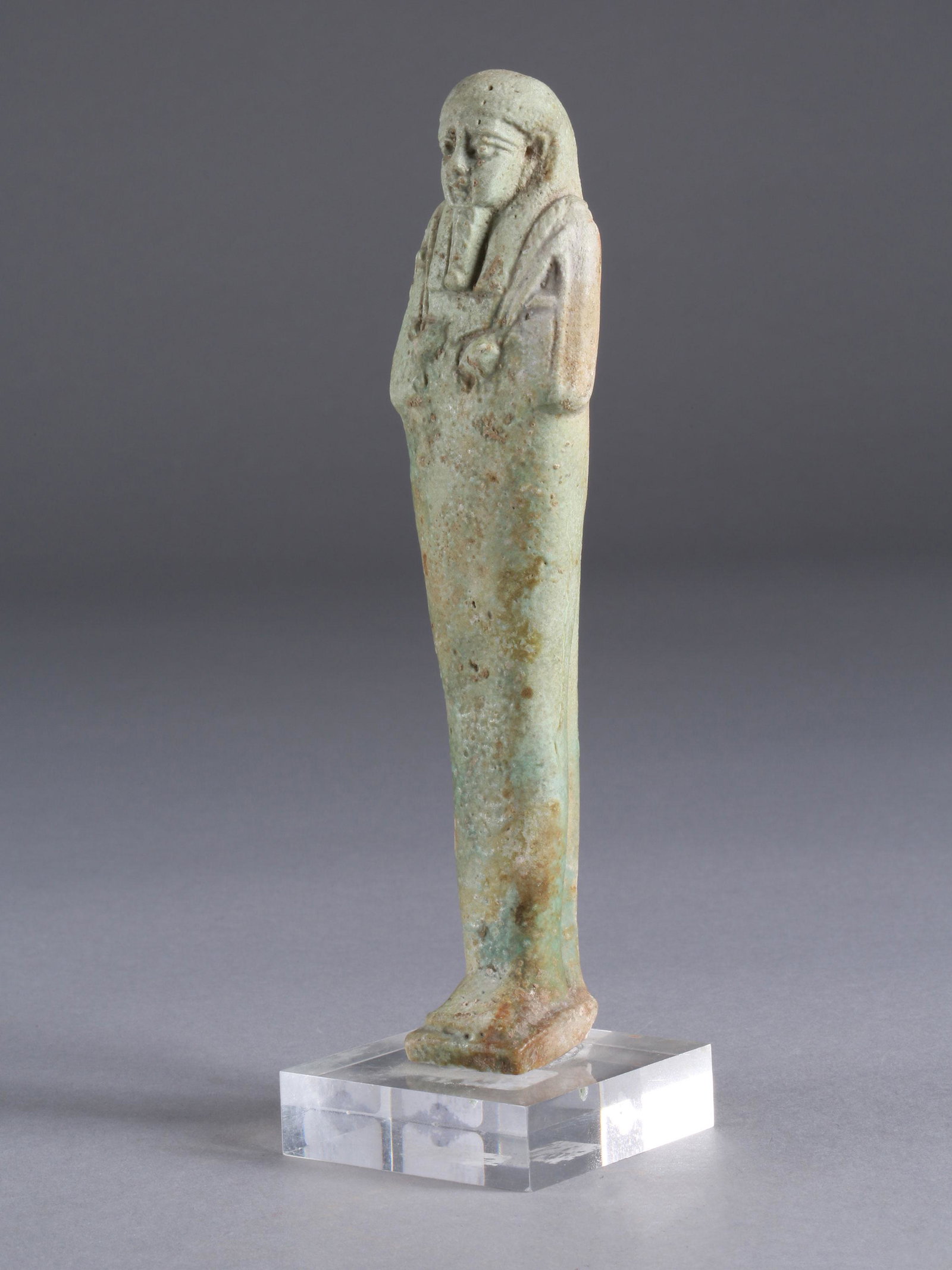 An Egyptian Ushabti: USHEBTI Ägyptisch Mit Sockel / with base Fayence. H 17 cm. Provenienz: Galerie Serodine, Ascona. CHF 100 / 200 EUR 86 / 172