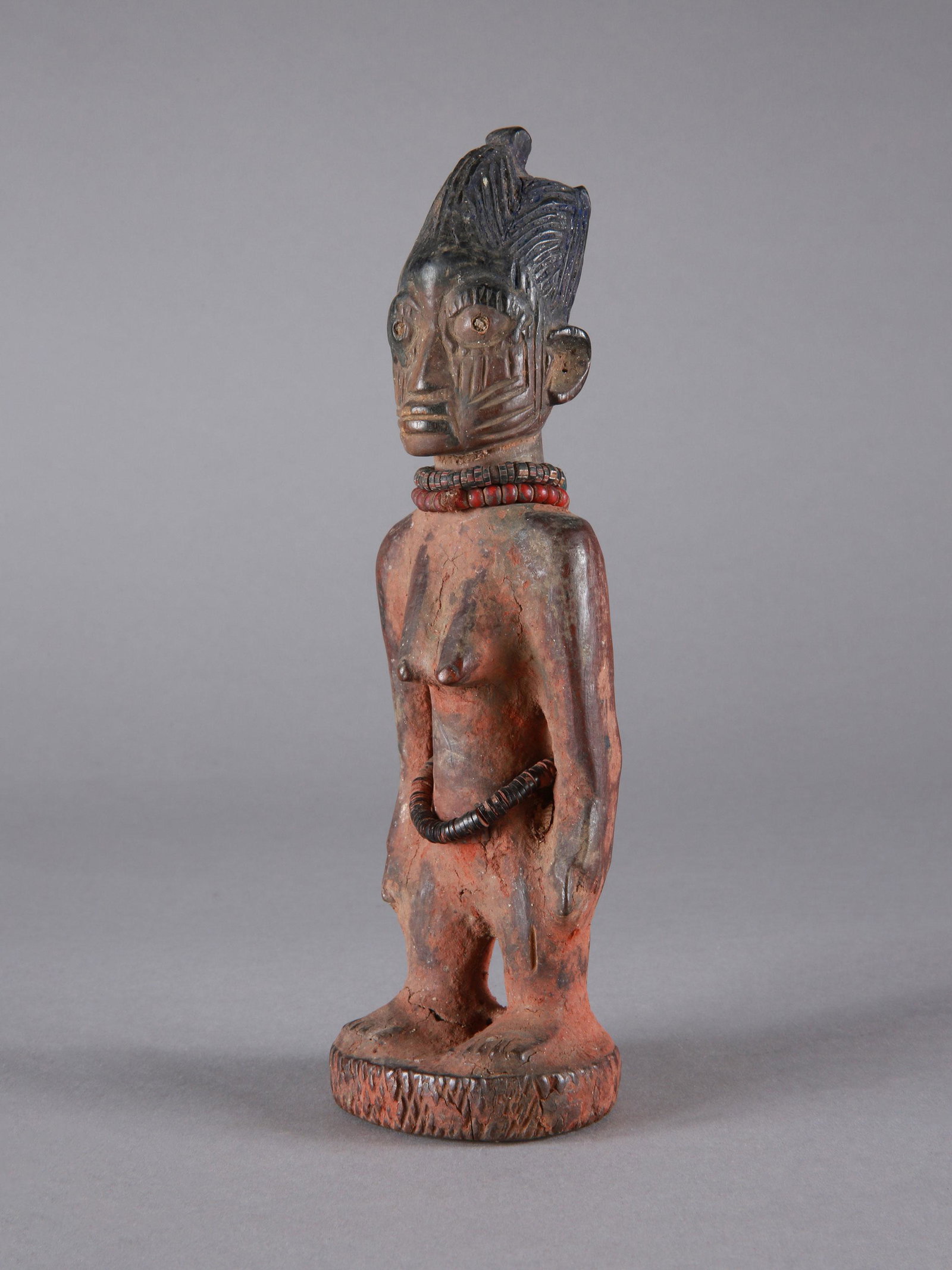 A Yoruba Twin Figure, "ere ibeji": Zwillingsfigur, "ere ibeji" Yoruba, Nigeria Ohne Sockel / without base Holz, Glasperlen, Kokosnussscheiben. H 22 cm. Provenienz: Andreas Vontobel (1931-2011), Waltalingen. Über Zwillinge wurde schon 