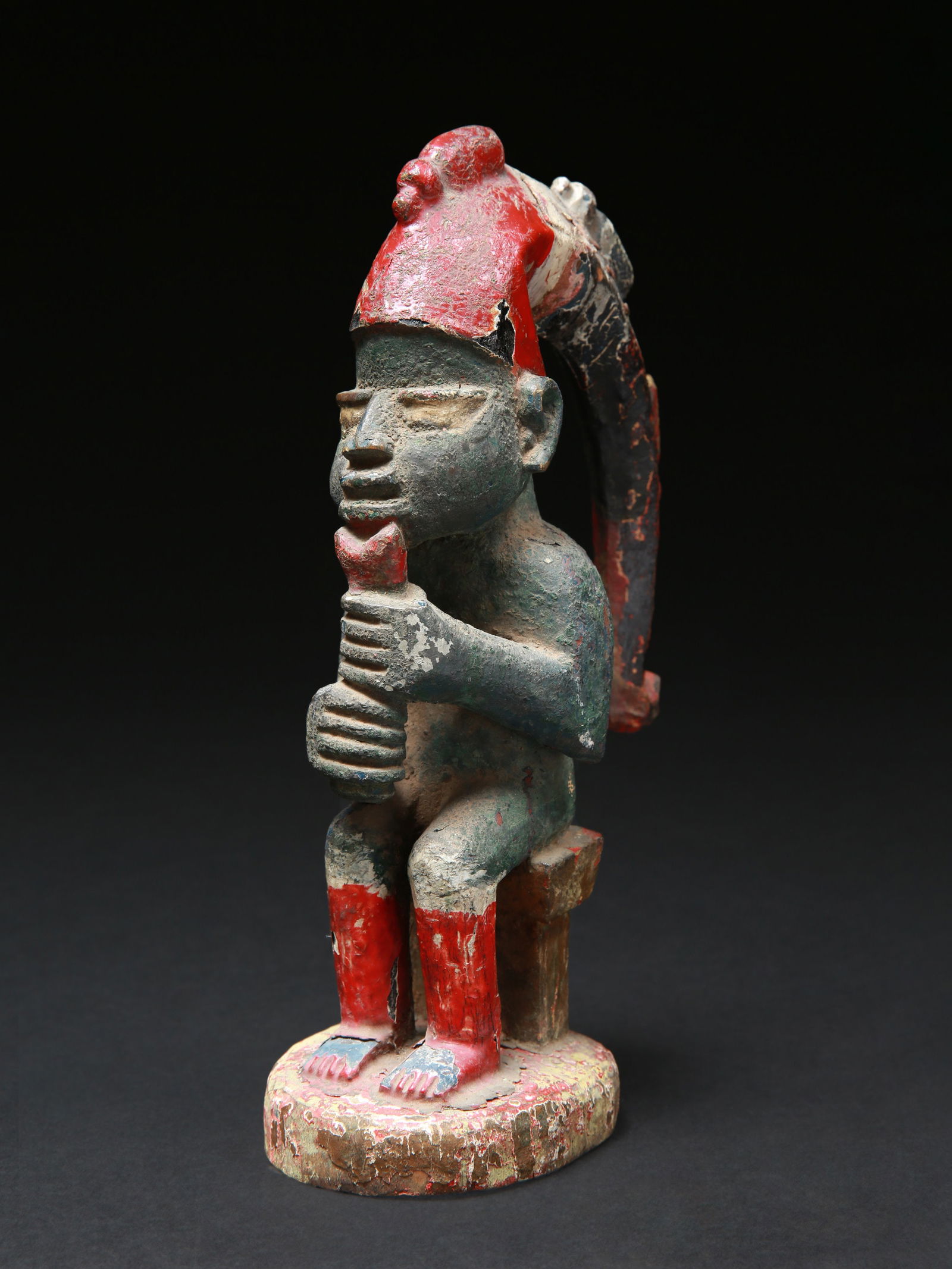 A Yoruba seated Flute Player, "eshu" (1 of 12)
