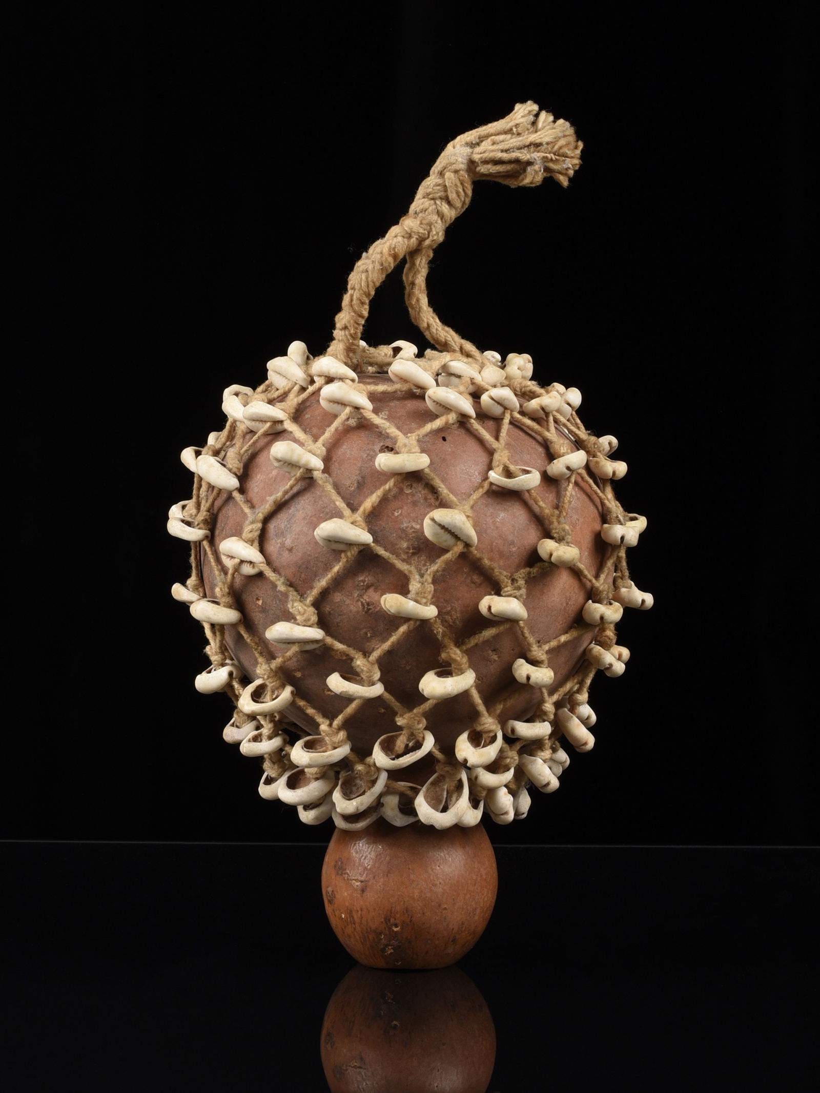 An Ewe Rattle: Rassel Ewe. Ghana / Togo Ohne Sockel / without base Kalebasse, Kaurischnecken, Schnur. H 19,5 cm. Provenienz: - Kurt Hösli-Brutschin (1928-2006), Basel. - Hammer Auktionen, Basel (28.07.2018, Lot