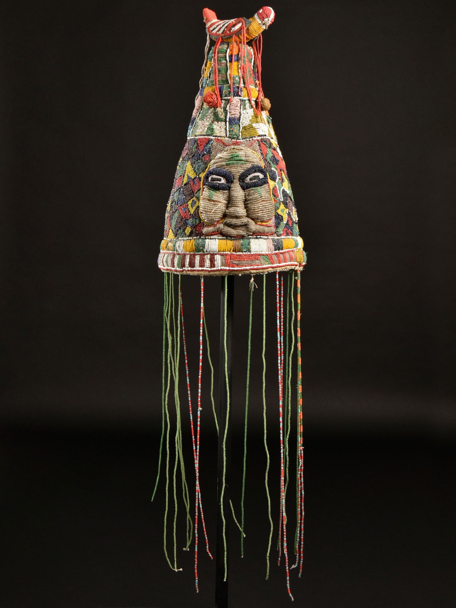 A Yoruba Beaded Crown, "ade": Perlenbestickte Krone, "ade" Yoruba. Nigeria Ohne Sockel / without base Textil, Glasperlen. H 41 cm. Provenienz: - René David (1928-2015), Zürich. - Jean David, Basel. - Hammer Auktionen,