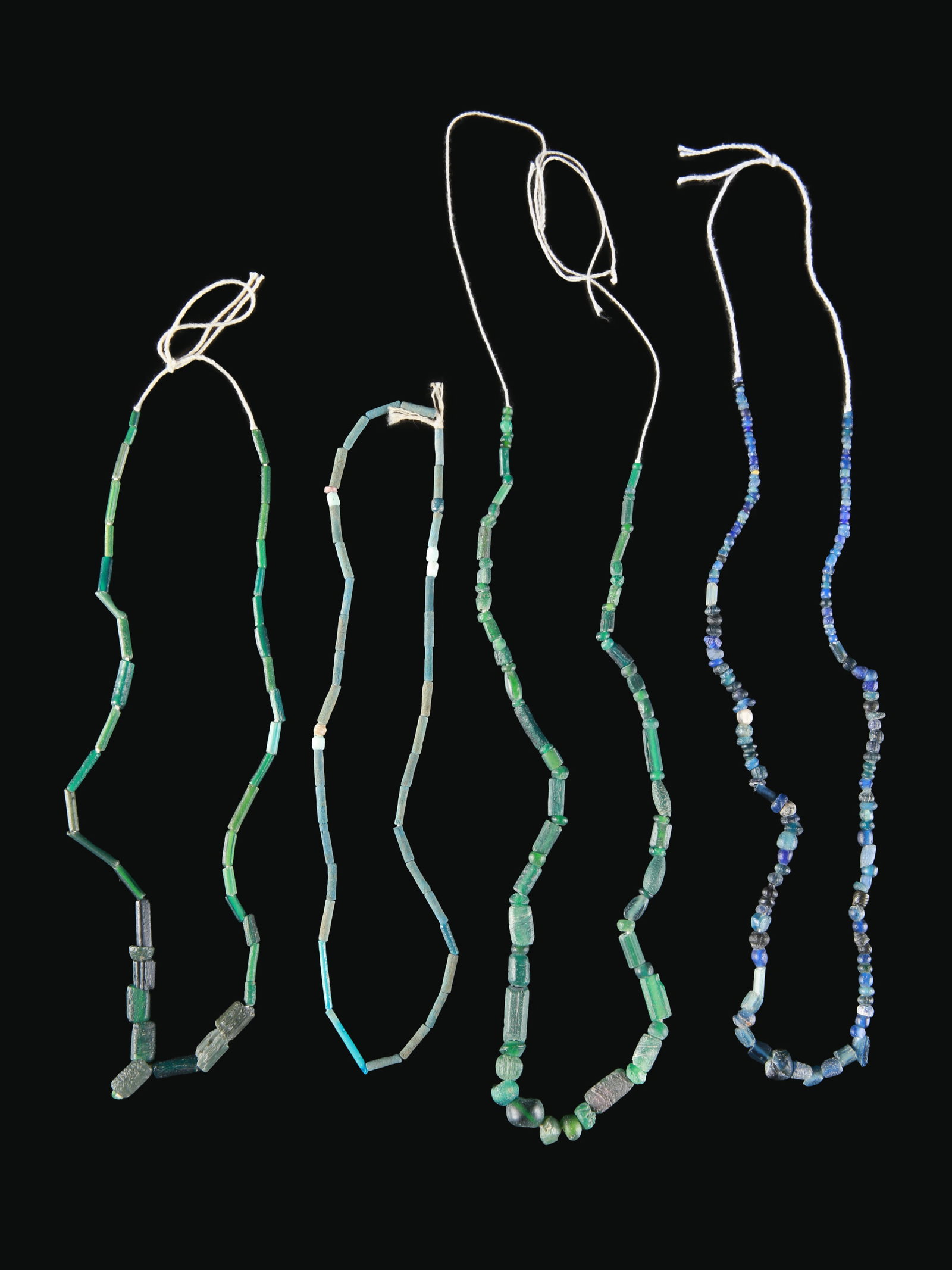 4 Egyptian Necklaces made of Faience Beads: 4 Colliers aus Fayence-Perlen Ägypten Ohne Sockel / without base Ägyptische Fayence. L 21 - 34 cm. Provenienz: - TimeLine Auctions, Harwich, 25.02.2020, Lot 0815. - Schweizer