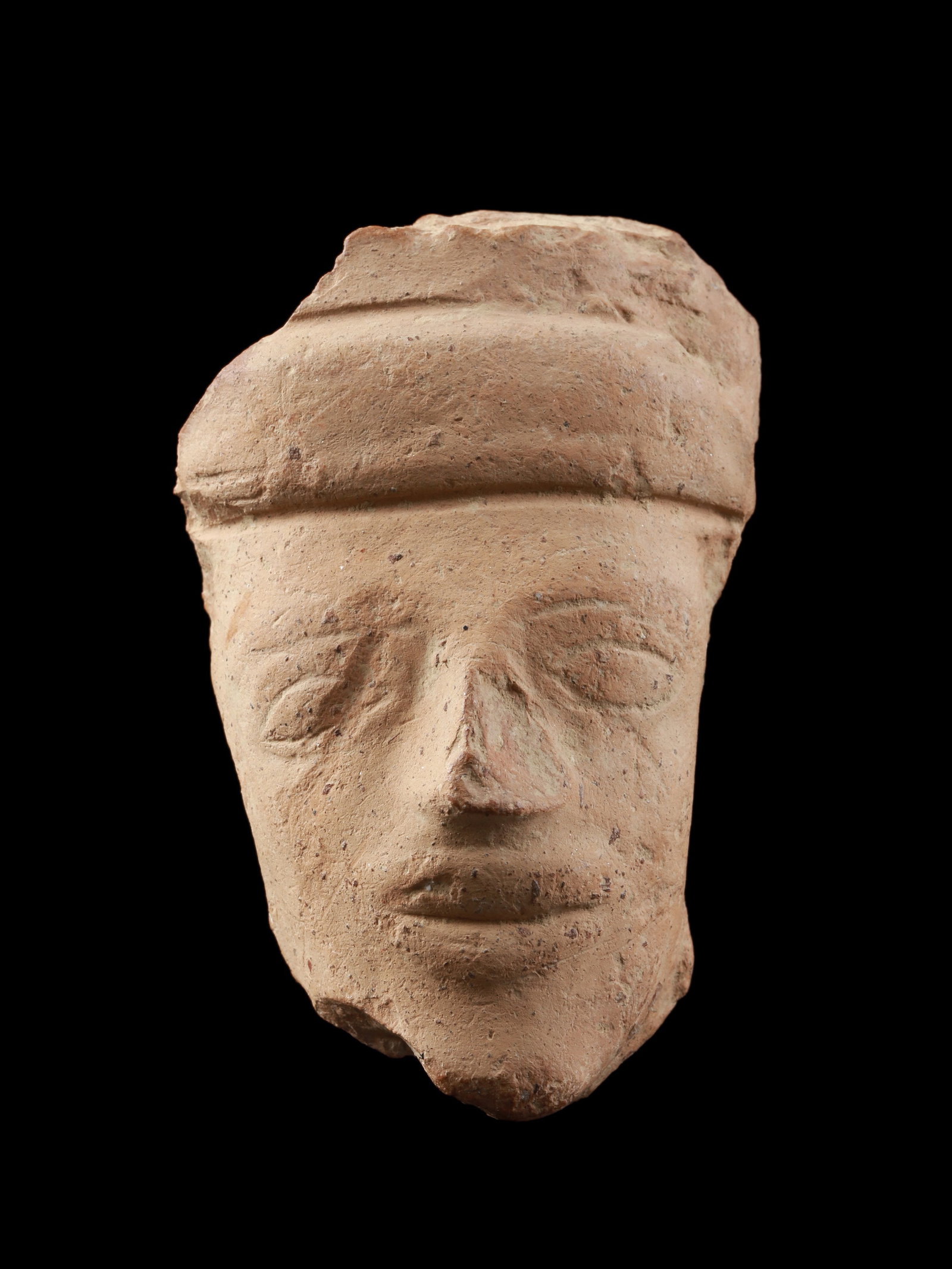 A Greek Terracotta Head of a Woman: Frauenkopf Griechisch Ohne Sockel / without base Terrakotta. H 8,5 cm. B 5,5 cm. Provenienz: - Wilhelm Dörpfeld (1853-1940). - Ernst Grumach (1902-1967), Berlin. - Gorny & Mosch, München
