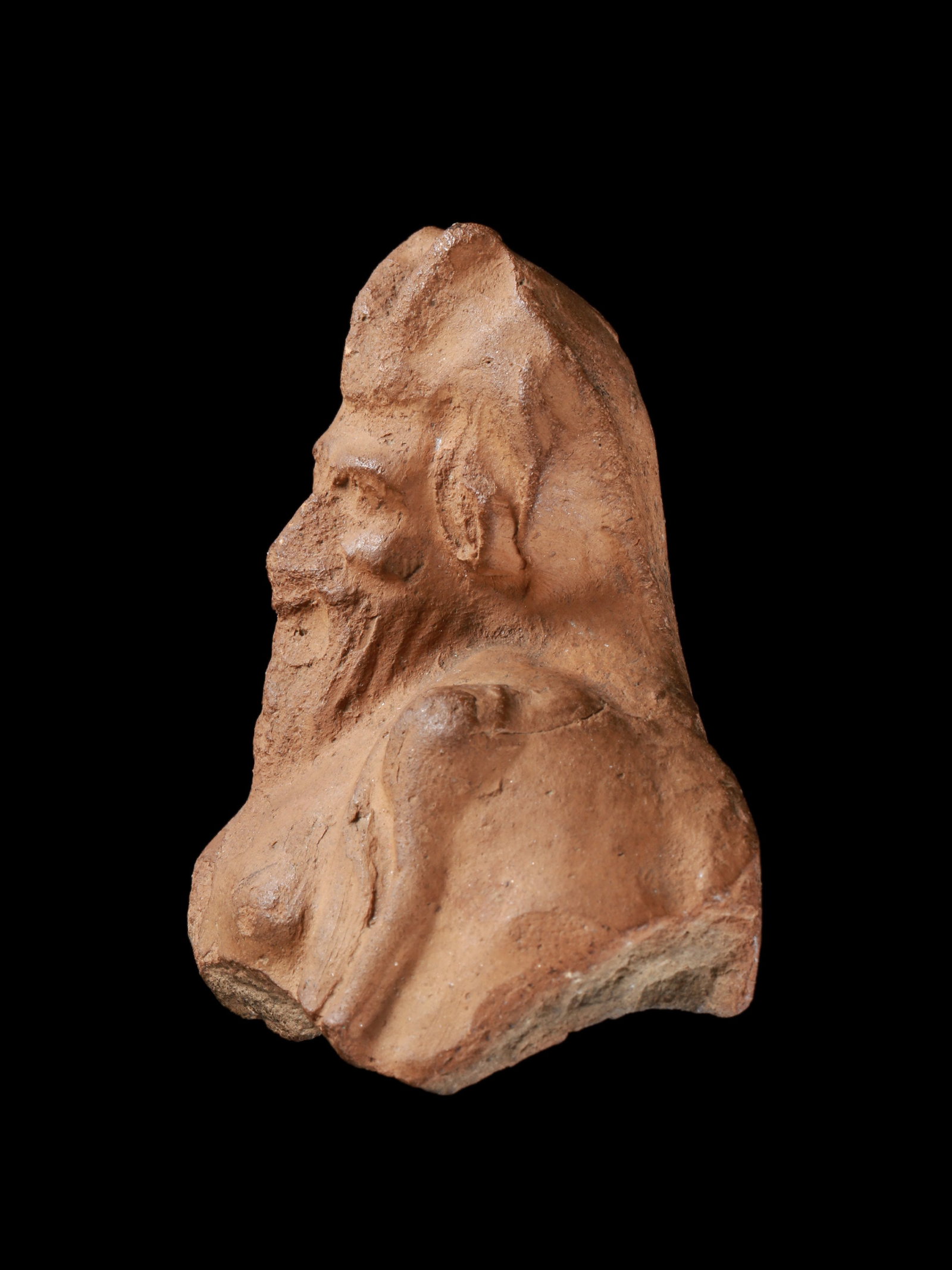 A Greek Head and Bust of Pan with Lagobolon: Pan-Kopf und Oberkörper mit Lagobolon Griechisch Ohne Sockel / without base Terrakotta. H 7 cm. Provenienz: - Wilhelm Dörpfeld (1853-1940). - Ernst Grumach (1902-1967), Berlin. - Gorny &