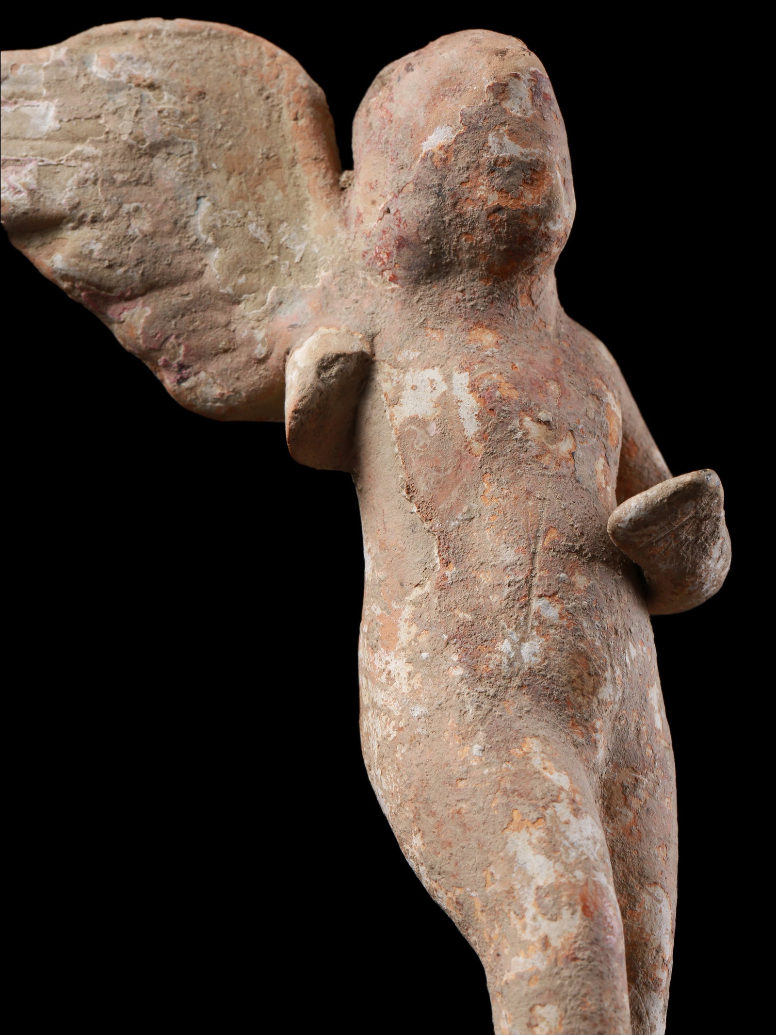 A Greek Statuette of Eros: Statuette des Eros Griechisch Ohne Sockel / without base Terrakotta. H 12 cm. Provenienz: - Wilhelm Dörpfeld (1853-1940). - Ernst Grumach (1902-1967), Berlin. - Gorny & Mosch, München
