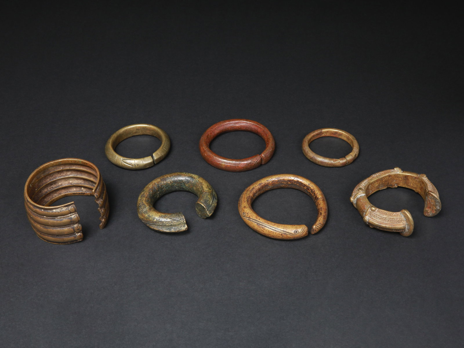 7 Armlets (Pre-Coinage Currencies): 7 Schmuckreife (vormünzliche Zahlungsmittel) Ohne Sockel / without base Gelbguss. Ø 6 - 8 cm. Provenienz: - Rainer Köhler (1931-2013), Comano/Kampala. Vor 1969 in situ erworben. - Ines