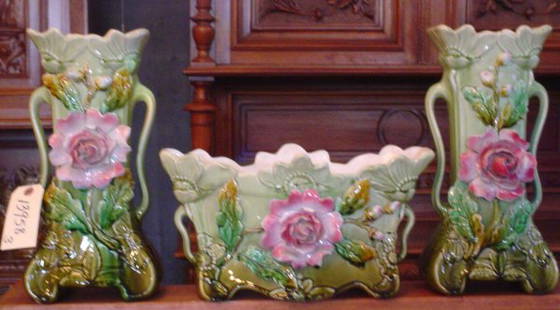 THREE PC MAJOLICA GARNITURE SET 13958: Lovely three piece majolica garniture set with blown out roses and flowers.Dimensions: Middle Planter:14.5" W x 7.5" H Sides: 7" W x 14" H Age: C. 1910 Material: Pottery & Majolica