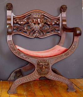 CARVED WALNUT CHAIR NORTH WIND FACE 879: Highly detailed carved walnut chair with North wind face backrest and lion head upper finials and lower accent.Dimensions: 37"H x 28.25"W x 22"D Age: C. 1870 Material: Walnut