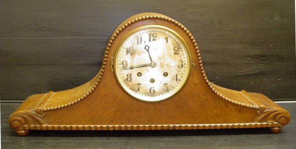 OAK MANTLE CLOCK 14092: Lovely oak mantle clock. Dimensions: 11" H x 26 1/4" W x 6 3/4" D Age: C. 1920 Material: Oak