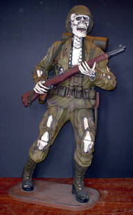 LIFE SIZE SKELETON SOLDIER 819: Life-size skeleton soldier in fatigues. Great as a Halloween decoration. Dimension: 71"H x 40"W x 37"D Age: Contemporary Material: Composite