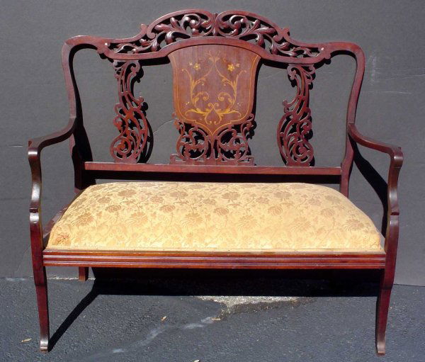 INLAID BENCH WITH PIERCED BACK 1166: Dainty inlaid double bench with pierced accents and gold fabric. Dimensions: 38 1/2" H x 43 1/2" W x 21" D Age: C. 1890 Material: Wood