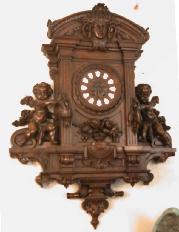 PHENOMENAL LG WALNUT WALL CLOCK WITH CUPIDS 14460: Phenomenal carved walnut heavily carved wall clock with crisp high quality workmanship. The prominent details include large side winged cherubs holding hanging game, Jenny Lynn head crest, nuts and be