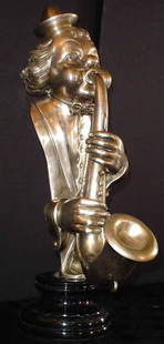 CHROME OVER BRASS STATUE OF CLOWN 12606: Remarkable chrome over brass statue of clown playing horn. Dimensions: 26" H x 9" W x 15 1/2" D Age: Contemporary Material: Bronze