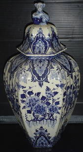 SIGNED DELFT LARGE COVERED JAR 3009: Signed delft large covered jar with flowers and lion top. Dimensions: 18"H x 9"Diameter Age: Material: Pottery