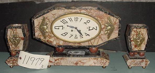 THREE PIECE DECO CLOCK SET 11979: Fancy three piece deco clock set with black, red, and white marble, also bronze mounted flowers and oval face. Dimensions: Clock: 12 1/2" H x 16 3/4" W x 5" D Sides: 8 3/4" H x 4 1/2" W x 4 1/4" D 