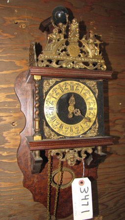 SM WALL ATLAS CLOCK WITH MAN 3471: Small wood atlas wall clock. Dimensions: 23"H x 10"W x 6"D Age: C. 1890 Material: Wood