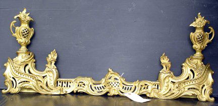 3 PC BZ FRENCH RECOCO CHENETS W/ CTR STRECHER 3100: Three piece French recoco bronze chenets /andiron set with center strecher and flame top urns. Dimensions: 16 1/2"H x 36"W (smallest) 51"W(widest) x 4 1/2"D Age:C.1880 Material: Bronze