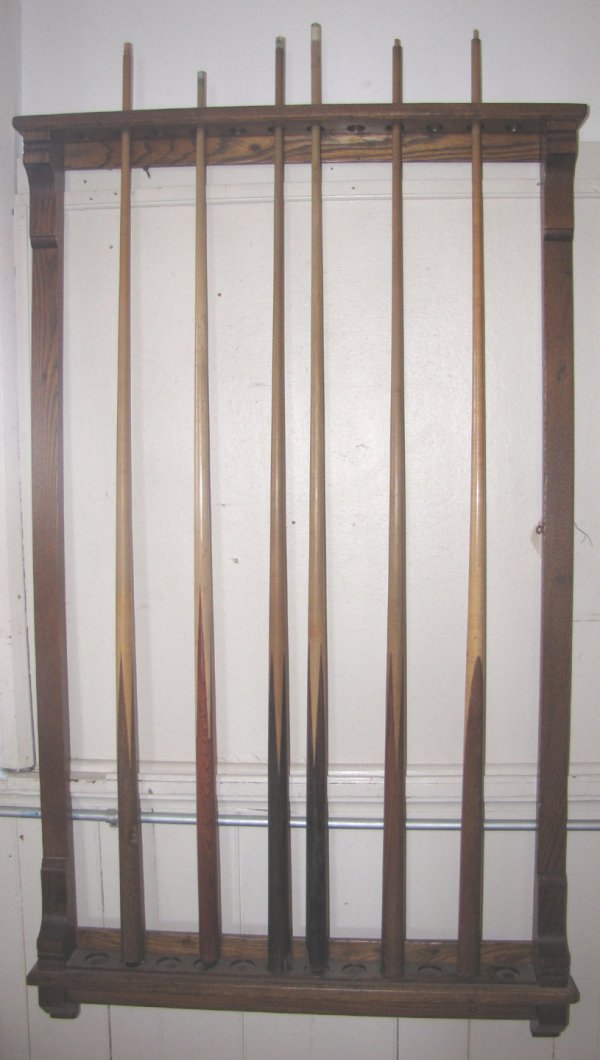 ANTIQUE AMERICAN OAK WALL CUE STICK RACK 1558: Oak wall cue stick rack that holds 12 sticks. Dimensions: 57"H x 34"W x 3"D Age: C. 1920 Material: Oak